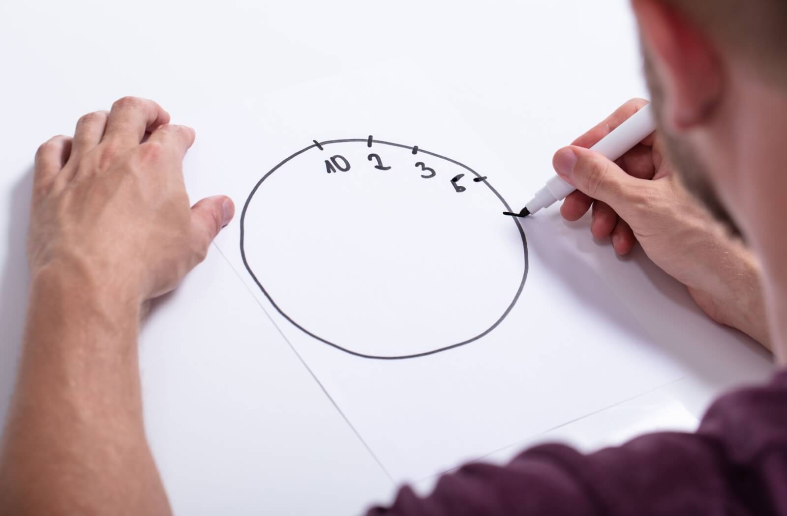 An older adult begins drawing a clock as part of the clock test, with four numbers written in wrong places.