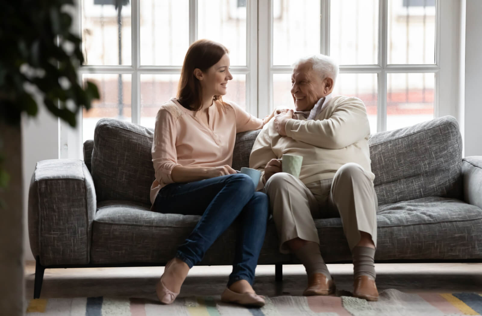 A woman visiting his older adult father in memory care.